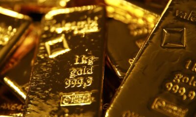 Gold declines to 8-week low on more potent buck, handovers